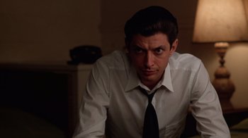 Movie still from “The Right Stuff” (1983), directed by Philip Kaufman – A man wearing a white shirt and a black tie; Close Up shot, Low angle