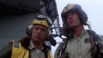 Movie still from “The Right Stuff” (1983), directed by Philip Kaufman – Two men in yellow jackets are standing next to each other; Close Up shot, Low angle