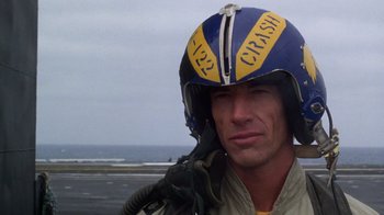 Movie still from “The Right Stuff” (1983), directed by Philip Kaufman – A man wearing a helmet on top of an airplane; Close Up shot, Low angle