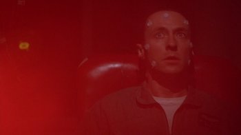 Movie still from “The Right Stuff” (1983), directed by Philip Kaufman – A man sitting in a chair looking up at the sky; Close Up shot, Low angle