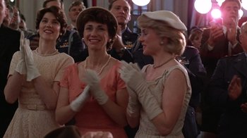 Movie still from “The Right Stuff” (1983), directed by Philip Kaufman – Two women are clapping in front of a group of people; Medium shot, Low angle