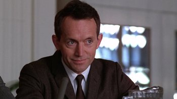 Movie still from “The Right Stuff” (1983), directed by Philip Kaufman – A person wearing a suit and tie; Close Up shot, Low angle