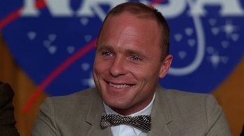 Movie still from “The Right Stuff” (1983), directed by Philip Kaufman – A person wearing a suit and a bow tie; Close Up shot, Low angle