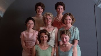Movie still from “The Right Stuff” (1983), directed by Philip Kaufman – A group of women standing next to each other in dresses; Medium shot, Low angle