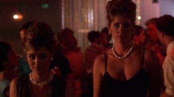 Movie still from “The Right Stuff” (1983), directed by Philip Kaufman – A woman in a black dress and a woman in pearls; Close Up shot, Low angle