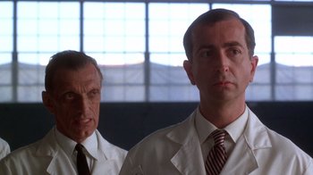 Movie still from “The Right Stuff” (1983), directed by Philip Kaufman – Two men in white lab coats standing next to each other; Close Up shot, Low angle