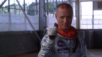Movie still from “The Right Stuff” (1983), directed by Philip Kaufman – A man in a spacesuit giving a thumbs up; Close Up shot, Low angle
