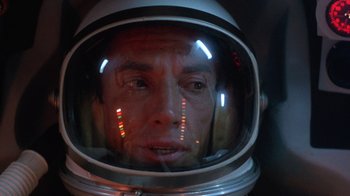 Movie still from “The Right Stuff” (1983), directed by Philip Kaufman – A person wearing a space helmet; Close Up shot, Overhead angle