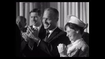 Movie still from “The Right Stuff” (1983), directed by Philip Kaufman – A black and white photo of two people clapping; Medium shot, Low angle