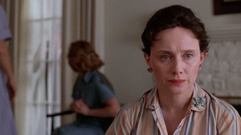 Movie still from “The Right Stuff” (1983), directed by Philip Kaufman – A woman in a striped shirt is looking at the camera; Close Up shot, Over the shoulder angle