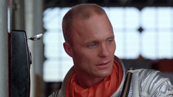 Movie still from “The Right Stuff” (1983), directed by Philip Kaufman – A person wearing a space suit; Close Up shot, Low angle