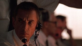Movie still from “The Right Stuff” (1983), directed by Philip Kaufman – A person wearing a headset; Close Up shot, Low angle