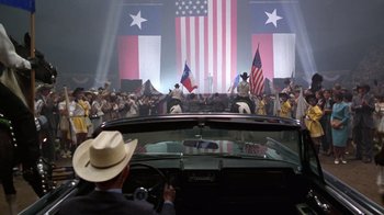 Movie still from “The Right Stuff” (1983), directed by Philip Kaufman – A crowd of people standing in front of an american flag; Wide shot, High angle