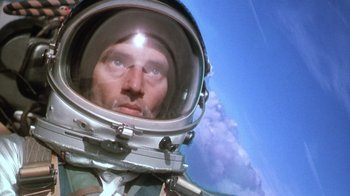 Movie still from “The Right Stuff” (1983), directed by Philip Kaufman – A person wearing a space suit; Close Up shot, Overhead angle