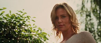 Movie still from “The Road” (2009), directed by John Hillcoat – A person wearing a white shirt near a tree; Close Up shot, Low angle