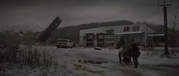 Movie still from “The Road” (2009), directed by John Hillcoat – An abandoned gas station in the middle of the snow; Extreme Wide shot, Low angle