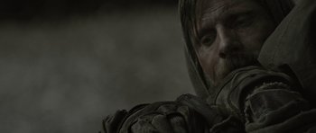 Movie still from “The Road” (2009), directed by John Hillcoat – A person wearing a hood; Close Up shot, Over the shoulder angle