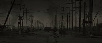 Movie still from “The Road” (2009), directed by John Hillcoat – People are standing in the middle of a desolate area; Extreme Wide shot, High angle