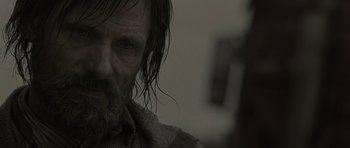 Movie still from “The Road” (2009), directed by John Hillcoat – A person with a beard; Close Up shot, Over the shoulder angle