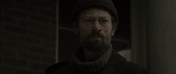 Movie still from “The Road” (2009), directed by John Hillcoat – A person wearing a hat; Close Up shot, Low angle
