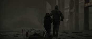 Movie still from “The Road” (2009), directed by John Hillcoat – A man and a child walking in the snow; Wide shot, Low angle