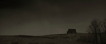 Movie still from “The Road” (2009), directed by John Hillcoat – An old house on a hill in the dark; Extreme Wide shot, Low angle