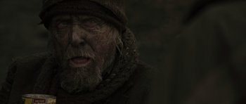 Movie still from “The Road” (2009), directed by John Hillcoat – An old man wearing a hat and a coat; Close Up shot, Over the shoulder angle