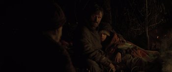 Movie still from “The Road” (2009), directed by John Hillcoat – A man and a woman sitting next to each other in the dark; Medium shot, Over the shoulder angle