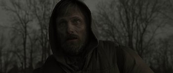 Movie still from “The Road” (2009), directed by John Hillcoat – A person wearing a hooded jacket; Close Up shot, Low angle