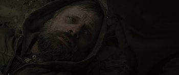 Movie still from “The Road” (2009), directed by John Hillcoat – A person wearing a hooded jacket; Close Up shot, Low angle