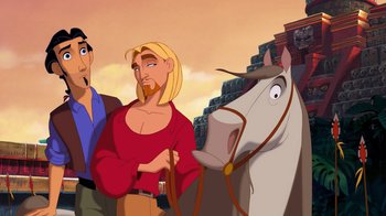 Movie still from “The Road to El Dorado” (2000), directed by Bibo Bergeron – Two men and a white horse are standing in front of a brick wall; Medium shot, Over the shoulder angle