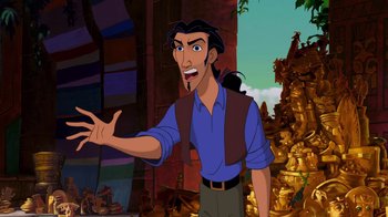 Movie still from “The Road to El Dorado” (2000), directed by Bibo Bergeron – A man with long black hair and a blue shirt is smiling; Medium shot, Over the shoulder angle