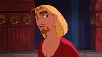 Movie still from “The Road to El Dorado” (2000), directed by Bibo Bergeron – A man with long blond hair and a beard; Close Up shot, Over the shoulder angle