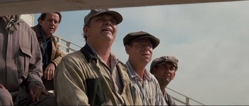 Movie still from “The Rocketeer” (1991), directed by Joe Johnston – A group of men standing next to each other on a field; Medium shot, Low angle