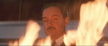 Movie still from “The Rocketeer” (1991), directed by Joe Johnston – A person wearing a suit and tie; Close Up shot, Low angle