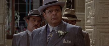 Movie still from “The Rocketeer” (1991), directed by Joe Johnston – A group of men in suits and hats standing next to each other; Close Up shot, Over the shoulder angle