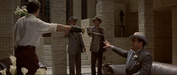 Movie still from “The Rocketeer” (1991), directed by Joe Johnston – A group of men standing next to each other; Medium shot, Over the shoulder angle