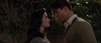 Movie still from “The Rocketeer” (1991), directed by Joe Johnston – A man and a woman standing next to each other; Close Up shot, Over the shoulder angle