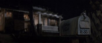 Movie still from “The Rocketeer” (1991), directed by Joe Johnston – A mail box in front of a house at night; Wide shot, Low angle
