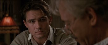 Movie still from “The Rocketeer” (1991), directed by Joe Johnston – A man sitting in front of another man in front of a mirror; Close Up shot, Over the shoulder angle
