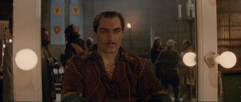 Movie still from “The Rocketeer” (1991), directed by Joe Johnston – A person with a beard and mustache; Close Up shot, Over the shoulder angle