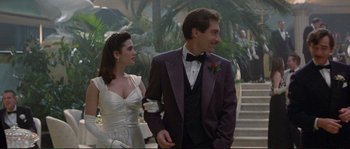 Movie still from “The Rocketeer” (1991), directed by Joe Johnston – A man and a woman in formal wear walking down a staircase; Medium shot, Low angle