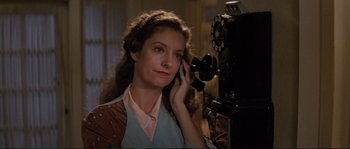 Movie still from “The Rocketeer” (1991), directed by Joe Johnston – A woman holding a phone up to her ear; Close Up shot, High angle