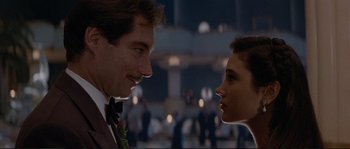 Movie still from “The Rocketeer” (1991), directed by Joe Johnston – A man and a woman looking at one another in front of a crowd of onlookers; Close Up shot, Low angle