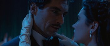 Movie still from “The Rocketeer” (1991), directed by Joe Johnston – A person wearing a suit and a bow tie; Close Up shot, Over the shoulder angle