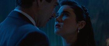 Movie still from “The Rocketeer” (1991), directed by Joe Johnston – A man and a woman face to face in the dark; Close Up shot, Over the shoulder angle