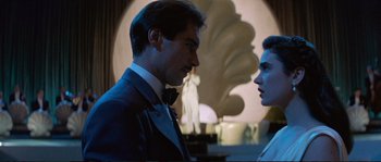 Movie still from “The Rocketeer” (1991), directed by Joe Johnston – A man and a woman standing next to each other in a room; Medium shot, Low angle