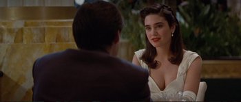Movie still from “The Rocketeer” (1991), directed by Joe Johnston – A man and a woman sitting in front of each other at a table; Close Up shot, Over the shoulder angle