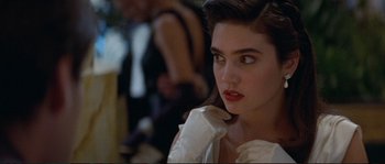 Movie still from “The Rocketeer” (1991), directed by Joe Johnston – A person wearing gloves and a white dress; Close Up shot, Over the shoulder angle