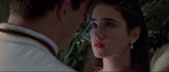 Movie still from “The Rocketeer” (1991), directed by Joe Johnston – A man and a woman looking at each other in front of a tree; Close Up shot, Over the shoulder angle